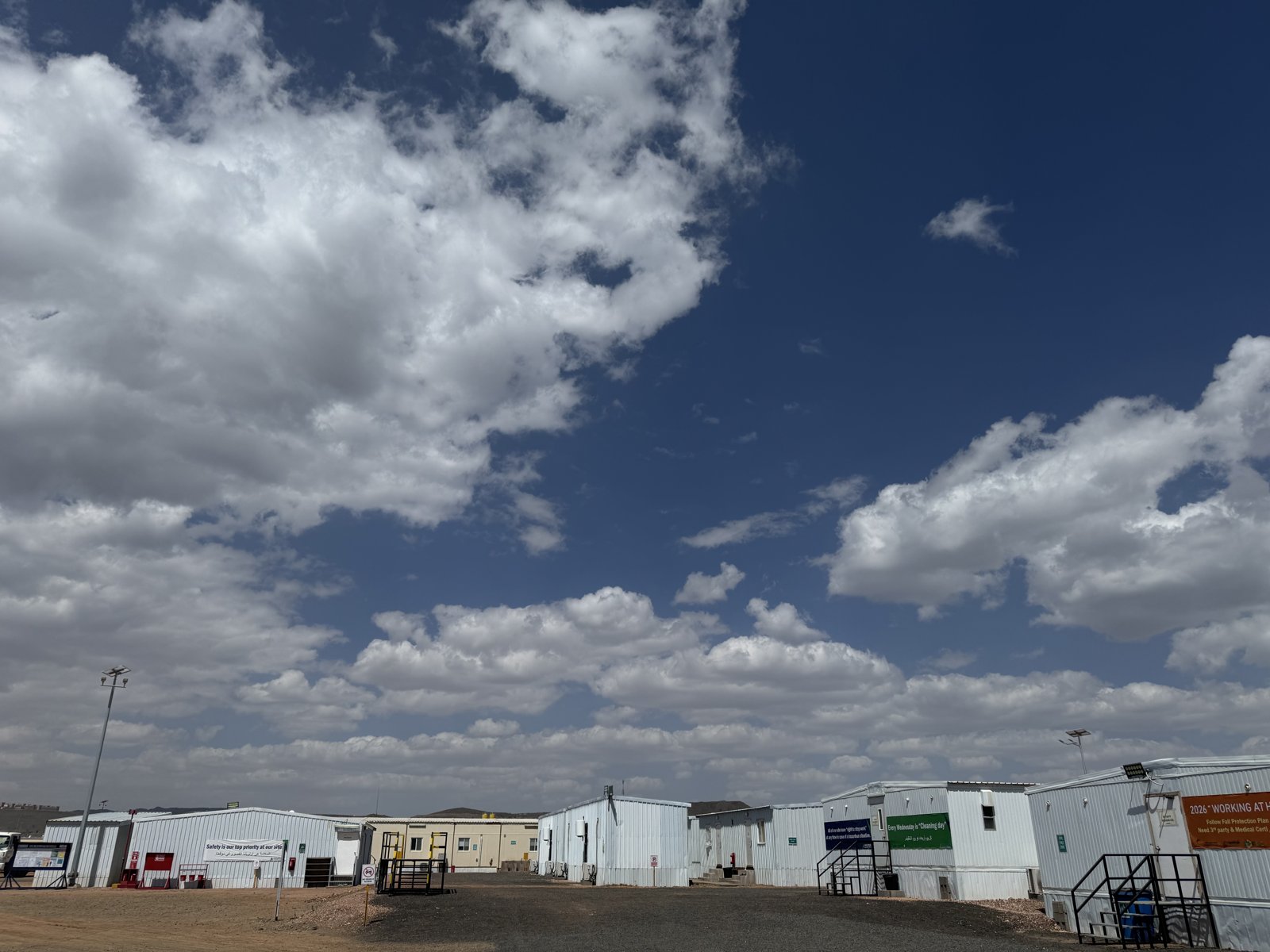 Modular site buildings, access steps and outdoor lighting within the site compound.
